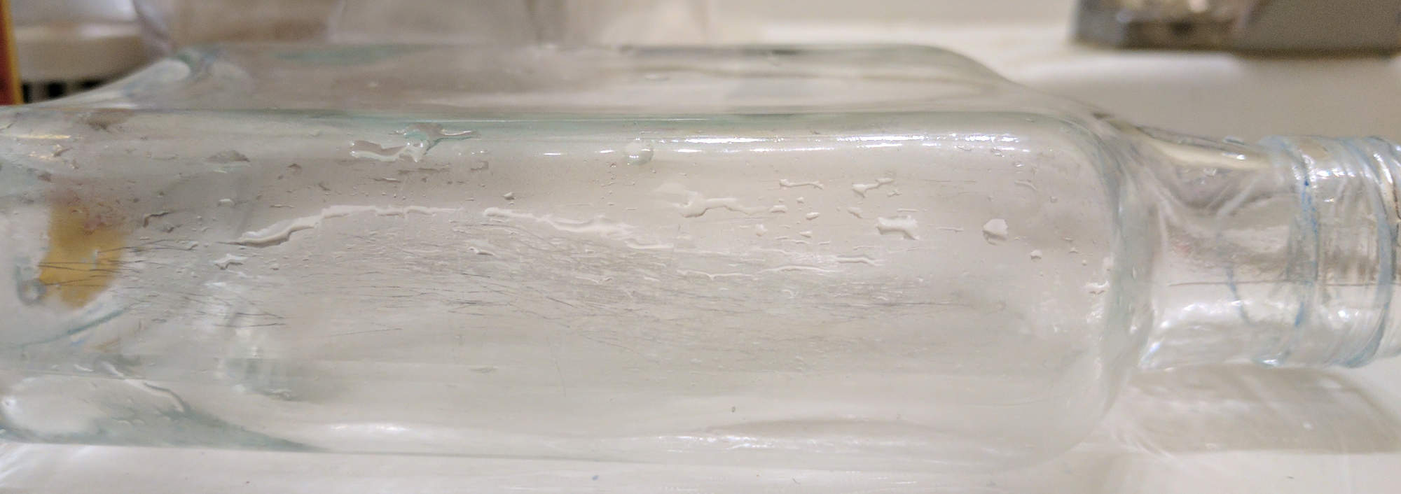 The scratches on the underside of the bottle